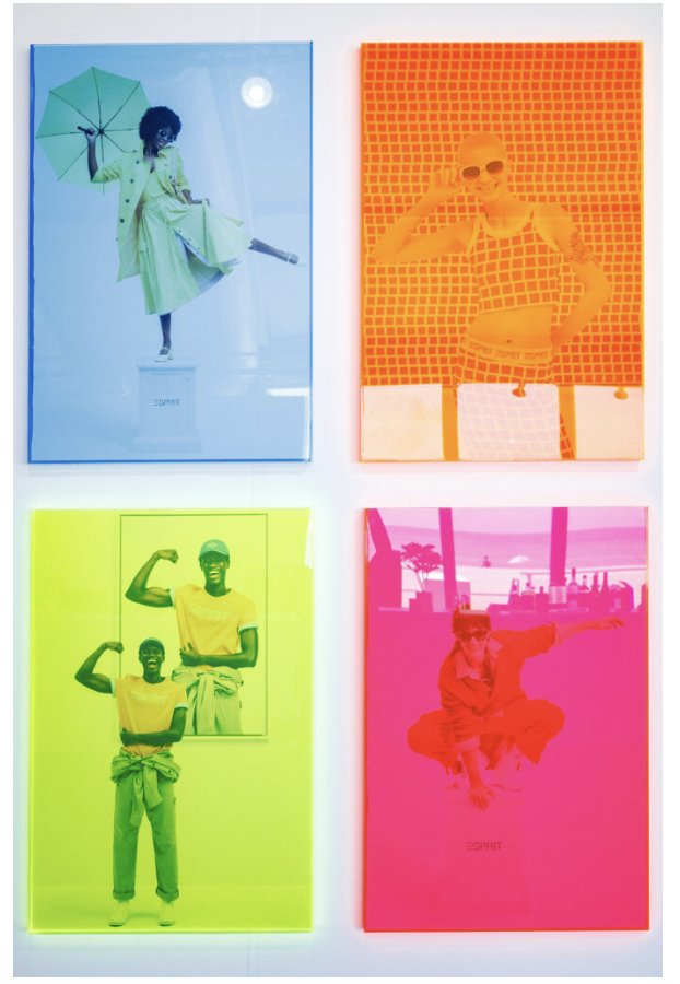 Four screen-printed Esprit posters in vivid colors hung as a media wall